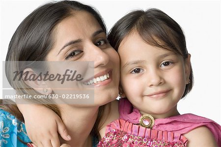Portrait of a young woman smiling with her daughter