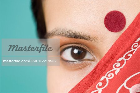 Close-up of a young woman's face covered with a stole