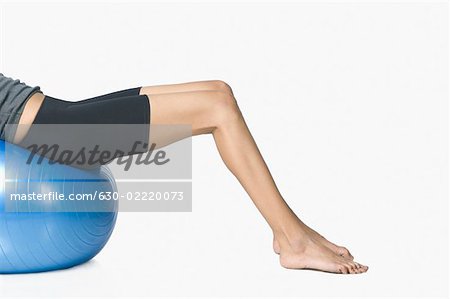 Young woman exercising with a fitness ball