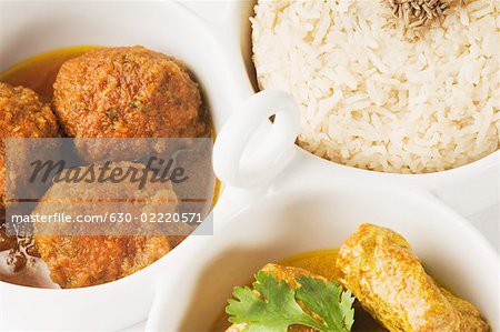 Close-up of koftas curry and boiled rice and meatballs in bowls