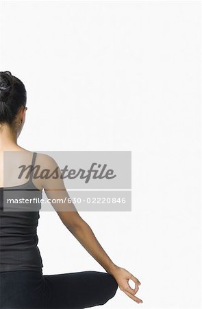Rear view of a young woman meditating
