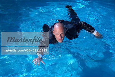 Businessman Swimming in Pool