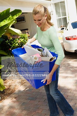 Woman Taking the Recycling to the Curb