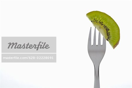 Dessert fork with a slice of kiwi on it