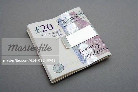 Twenty pound notes in money clip Twenty pound notes in money clip