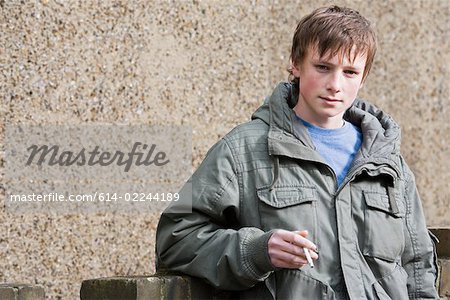 Portrait of a teenage boy smoking