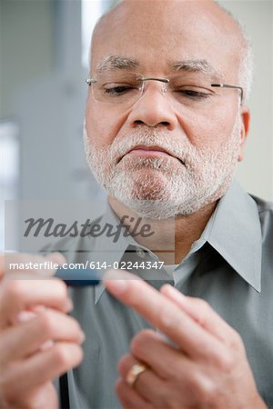 A man doing a home blood glucose testing