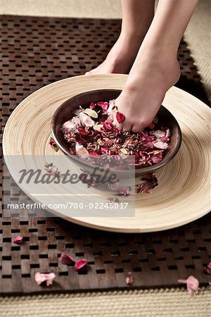 Woman Soaking Her Feet in Scented Water