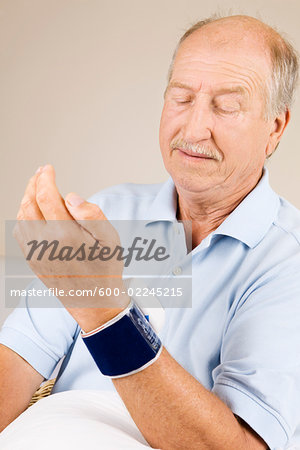 Man Looking at Pulse Meter on Wrist