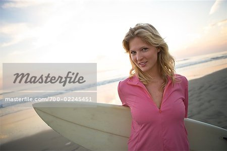 Portrait of Woman With Surfboard on the Beach at Dusk, Encinitas, San Diego County, California, USA