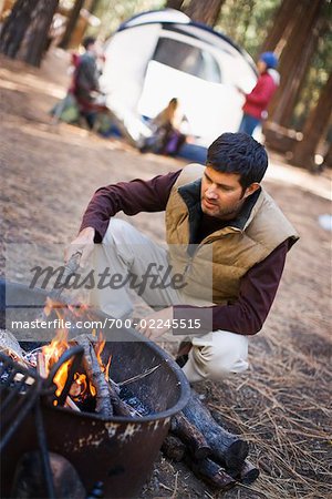 Man Stoking Campfire, Yosemite National Park, California, USA
