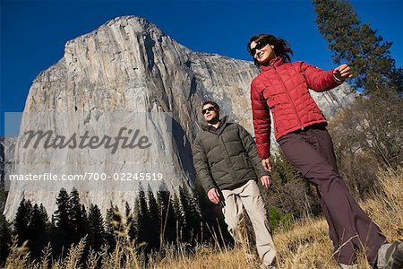 Couple Walking through El Capitan Meadow, Yosemite National Park, California, USA
