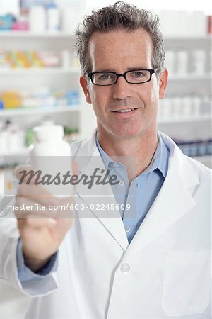 Portrait of Pharmacist Holding Bottle of Pills