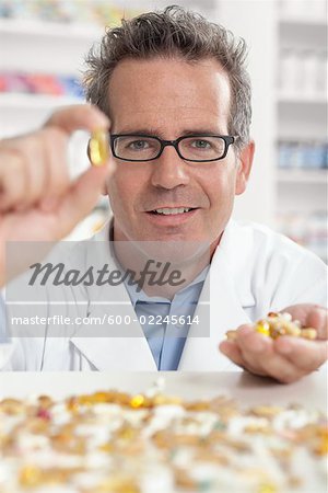 Portrait of Pharmacist With Handful of Pills