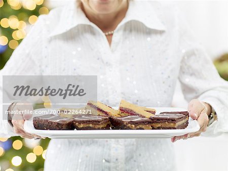 Close-up of Woman Holding Tray of Desserts