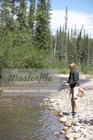 Woman Fishing in Chambers Creek, Alberta, Canada
