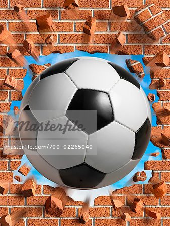 Soccer Ball Smashing Through Brick Wall