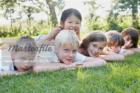 Group Portrait of Kids Lying Down Outdoors, Elmvale, Ontario, Canada