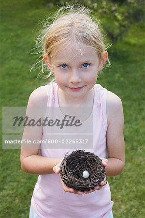 Portrait of Little Girl Holding a Bird's Nest With One Egg, Elmvale, Ontario, Canada