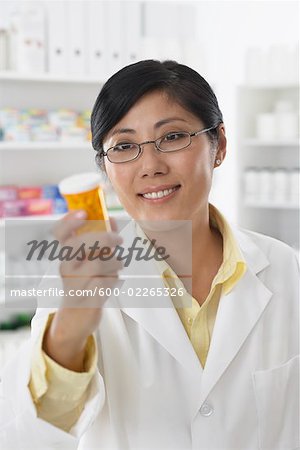 Portrait of Pharmacist Holding Pill Bottle