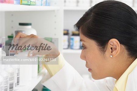 Pharmacist Looking at Pills on Shelf