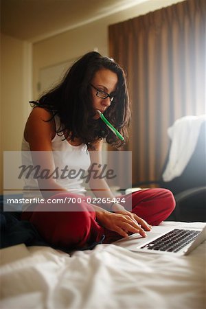 Woman Using Laptop Computer in Hotel Room