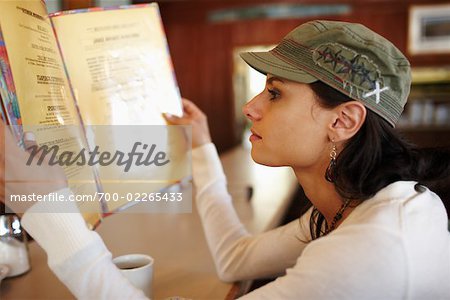 Woman Looking at Restaurant Menu