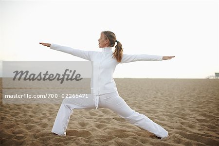 Woman Practicing Yoga on Beach, Santa Monica, California, USA