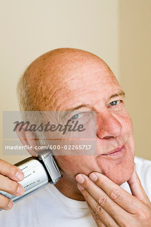 Man Shaving with Electric Razor