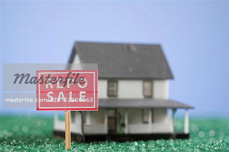 Repo sale sign board in front of a model home