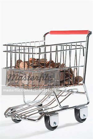 Close-up of coins in a shopping cart