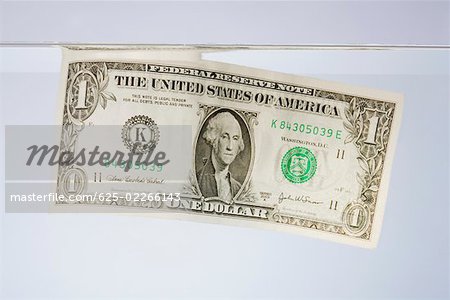 Gros plan d'un billet d'un dollar dans l'eau