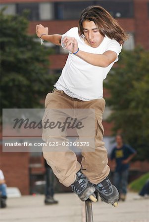 Young man skating on a pipe