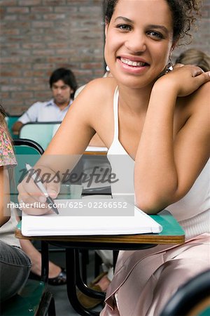 Portrait of a teenage girl smiling in a classroom