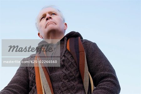 Low angle view of a senior man thinking