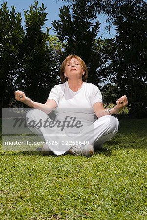 Senior woman sitting in lotus position