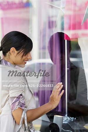 Side profile of a young woman window shopping