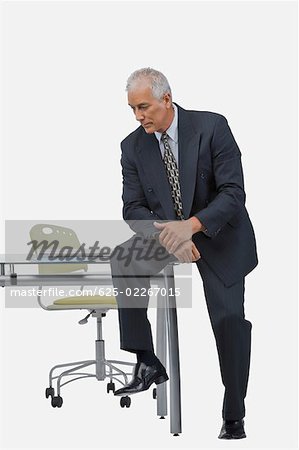 Businessman sitting at a desk in an office and thinking