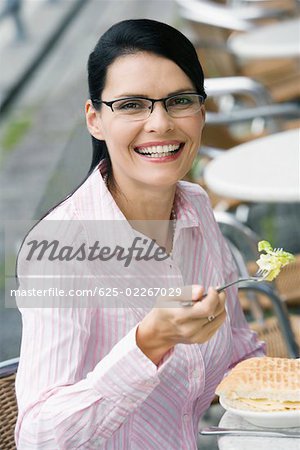 Portrait of a businesswoman having lunch at a sidewalk cafe