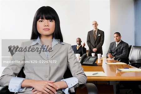 Portrait of a businesswoman with her colleagues in the background