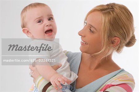 Close-up of a mid adult woman consoling her son