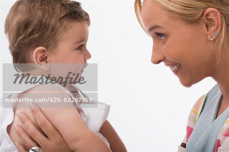 Close-up of a mid adult woman smiling with her son