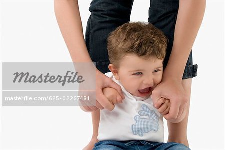 Close-up of a woman's hands holding a baby boy