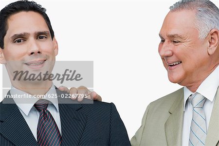 Close-up of a businessman putting his hand on another businessman's shoulders