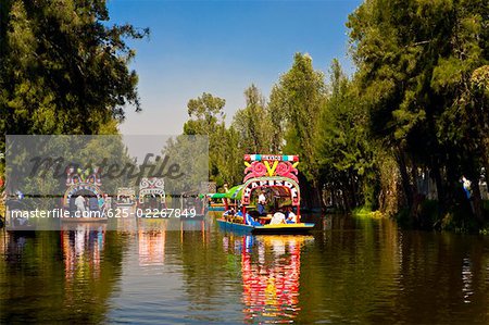 Tourists on trajineras boats in a canal, Xochimilco Gardens, Mexico City, Mexico