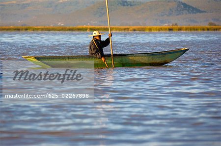 Side profile of a senior man fishing in a lake