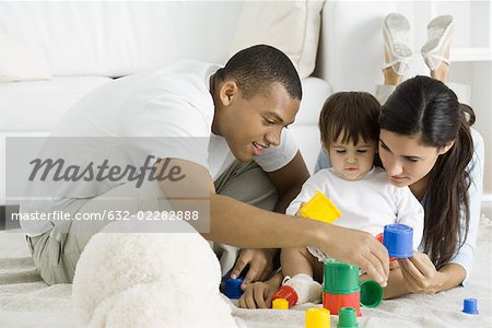 Eltern und Kleinkind Mädchen spielen mit Bausteinen Stock