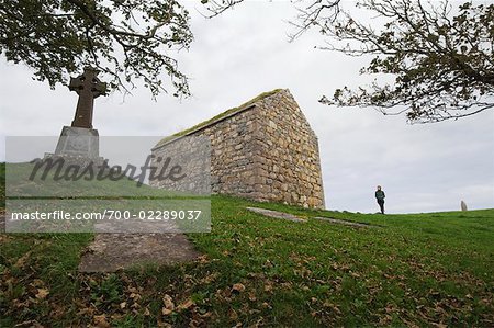 Frau zu Fuß durch Spiddal, Friedhof, County Galway, Galway, Irland
