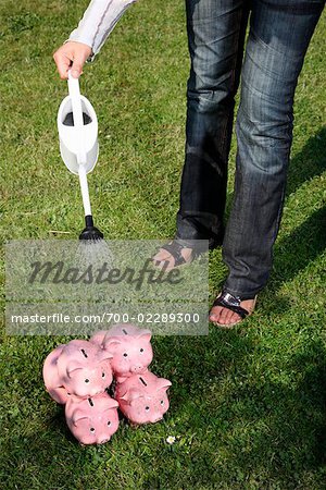 Woman Watering Piggy Banks