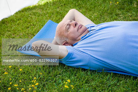 Man Lying on Exercise Mat Outdoors